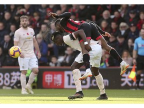 Bournemouth's Jefferson Lerma, bottom, and Manchester United's Paul Pogba battle for the ball during the English Premier League soccer match between Bournemouth and Manchester United at The Vitality Stadium, Bournemouth, England.Saturday Nov. 3, 2018.