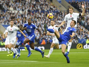 Leicester City's Jonny Evans, right, controls the ball in the air during the English Premier League soccer match between Leicester City and Burnley at the King Power stadium, Leicester, England. Saturday Nov. 10 2018