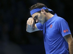 Switzerland's Roger Federer wipes his face during his ATP World Tour Finals singles final tennis match against Japan's Kei Nishikori at the O2 Arena in London, Sunday Nov. 11, 2018.