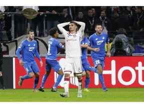 Lyon midfielder Houssem Aouar, center, reacts as Hoffenheim players celebrate their side's 2nd goal during a Champions League group F soccer match between Lyon and Offenheim in Decines, near Lyon, central France, Wednesday, Nov. 7, 2018.