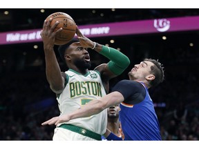 Boston Celtics' Jaylen Brown (7) shoots against New York Knicks' Mario Hezonja during the first half on an NBA basketball game in Boston, Wednesday, Nov. 21, 2018.