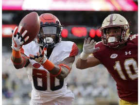 Syracuse wide receiver Taj Harris (80) catches a pass for a touchdown ahead of Boston College defensive back Brandon Sebastian (10) during the second half of an NCAA college football game, Saturday, Nov. 24, 2018, in Boston.