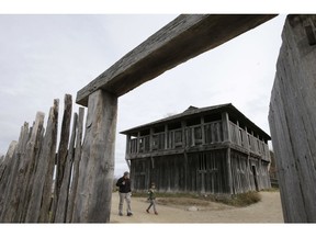 CORRECTS SPELLING OF PLANTATION NAME TO PLIMOTH INSTEAD OF PLYMOUTH - In this Sunday, Nov. 18, 2018, photo, visitors walk past a fort at Plimoth Plantation living history museum village, in Plymouth, Mass., where visitors can get a glimpse into the world of the 1627 Pilgrim village. Plymouth, where the Pilgrims came ashore in 1620, is gearing up for a 400th birthday, and everyone's invited, especially the native people whose ancestors wound up losing their land and their lives.