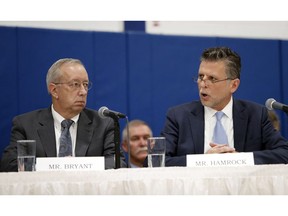 As Steve Bryant, left, the President of Columbia Gas of Massachusetts looks on, Joe Hamrock, right, President and CEO of NiSource, speaks to U.S. Senators and Representatives during a hearing on gas pipeline safety in the Merrimack Valley Monday, Nov. 26, 2018, in Lawrence, Mass.