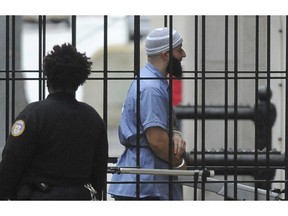 FILE - In this Feb. 3, 2016 file photo, Adnan Syed enters Courthouse East prior to a hearing in Baltimore. Maryland's highest court is set to hear arguments in the high-profile case of Syed whose murder conviction was chronicled in the hit "Serial" podcast. Two years after a new trial was ordered for Syed, the Maryland Court of Special Appeals on Thursday, Nov. 29, 2018, will hear oral arguments in the case. He was convicted in 2000 of strangling his ex-girlfriend and burying her body in a Baltimore park. Syed is serving a life sentence.