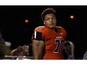 FILE - In this Sept. 16, 2016, file photo, McDonogh high school football lineman Jordan McNair watches from the sideline during a game in McDonogh, Md. Maryland has fired two trainers that were involved in the treatment of Jordan McNair after he collapsed on the field and subsequently died of heatstroke. Maryland has not formally announced the decision and has never named the trainers, but The Associated Press reported in August Wes Robinson and Steve Nordwall had been placed on leave.