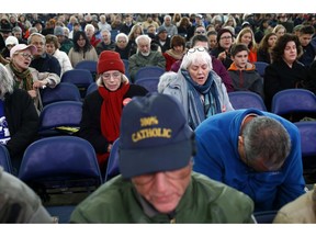 People pray the rosary at a rally organized by a coalition of conservative Catholic groups near the United States Conference of Catholic Bishops' annual fall meeting, Tuesday, Nov. 13, 2018, in Baltimore.