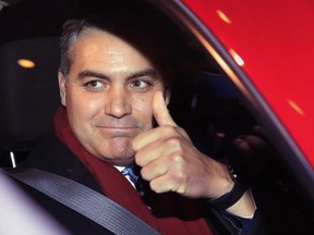 CNN's Jim Acosta gestures as he leaves federal court in Washington, Wednesday, Nov. 14, 2018, following a hearing on a legal challenge against President Donald Trump's administration over the revocation of his White House "hard pass."