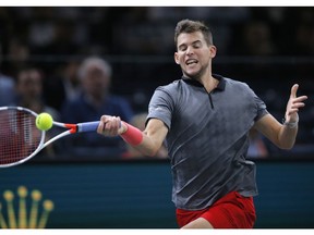 Dominic Thiem of Austria returns the ball to Karen Khachanov of Russia during their semifinal match of the Paris Masters tennis tournament at the Bercy Arena in Paris, France, Saturday, Nov. 3, 2018.