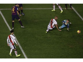 FC Barcelona's Luis Suarez, left, kicks the ball to score during the Spanish La Liga soccer match between FC Barcelona and Rayo Vallecano at the Vallecas stadium in Madrid, Spain, Saturday, Nov. 3, 2018.