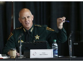 FILE- In this June 7, 2018 file photo Marjory Stoneman Douglas High School Public Safety Commission chair and Pinellas County Sheriff Bob Gualtieri gestures as he speaks during a commission meeting in Sunrise, Fla. Guiltieri says he now believes trained, volunteer teachers should have access to guns so they can stop shooters who get past other safeguards.