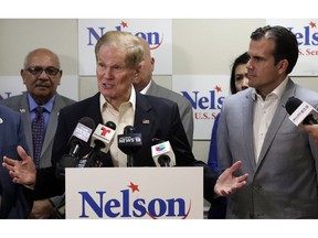 This Oct. 2, 2018 file photo shows U.S. Sen. Bill Nelson, left, speaking to supporters after he was endorsed by Puerto Rico Governor Ricardo Rossello, right, during a news conference in Orlando, Fla. Nelson is facing Florida Gov. Rick Scott.
