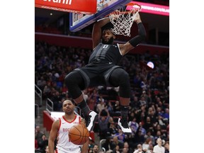 Detroit Pistons center Andre Drummond dunks as Houston Rockets guard Eric Gordon watches during the first half of an NBA basketball game Friday, Nov. 23, 2018, in Detroit.