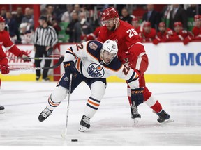 Edmonton Oilers right wing Tobias Rieder (22) controls the puck as Detroit Red Wings defenseman Mike Green (25) defends during the first period of an NHL hockey game, Saturday, Nov. 3, 2018, in Detroit.