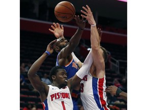 Detroit Pistons guard Reggie Jackson (1), New York Knicks guard Tim Hardaway Jr., and Pistons forward Blake Griffin, right, reach for a rebound during the first half of an NBA basketball game Tuesday, Nov. 27, 2018, in Detroit.