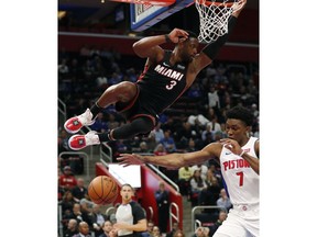 Detroit Pistons forward Stanley Johnson (7) reaches for the ball after a dunk by Miami Heat guard Dwyane Wade during the second half of an NBA basketball game, Monday, Nov. 5, 2018, in Detroit.