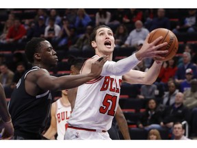 Chicago Bulls guard Ryan Arcidiacono (51) drives on Detroit Pistons guard Reggie Jackson, left, during the first half of an NBA basketball game in Detroit, Friday, Nov. 30, 2018.