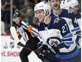 Winnipeg Jets left wing Nikolaj Ehlers (27), of Denmark, celebrates a goal against the Minnesota Wild during the second period of an NHL hockey game Friday, Nov. 23, 2018, in St. Paul, Minn.