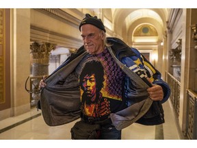 Former Minn. Governor Jesse Ventura talks to reporters after a meeting with Governor-elect Tim Walz inside the state Capitol in St. Paul, Minn., on Tuesday, Nov. 13, 2018. "I'm 67 with a six pack," Ventura said.