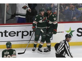 Minnesota Wild's Jordan Greenway (18) celebrates with Joel Eriksson Ek after Greenway scored a goal against the Ottawa Senators during the first period of an NHL hockey game Wednesday, Nov. 21, 2018, in St. Paul, Minn.