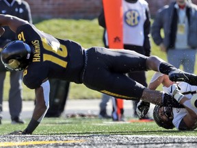 Missouri running back Damarea Crockett, left, dives into the end zone for a touchdown past Vanderbilt linebacker Dimitri Moore during the first half of an NCAA college football game Saturday, Nov. 10, 2018, in Columbia, Mo.