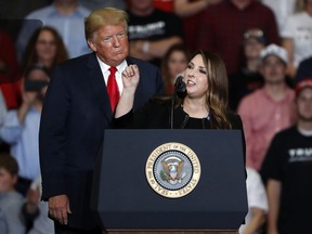 President Donald Trump listens as Chair of the Republican National Committee, Ronna McDaniel, right, speaks during a campaign rally Monday, Nov. 5, 2018, in Cape Girardeau, Mo.