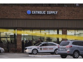 Authorities investigate the scene at a Catholic Supply store where a gunman went into the religious supply store, sexually assaulted at least one woman and shot a woman in the head, Monday, Nov. 19, 2018, in Ballwin, Mo.