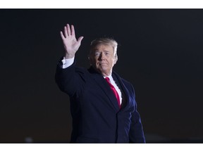 President Donald Trump waves after speaking during a rally for Sen. Cindy Hyde-Smith, R-Miss., at Tupelo Regional Airport, Monday, Nov. 26, 2018, in Tupelo, Miss.