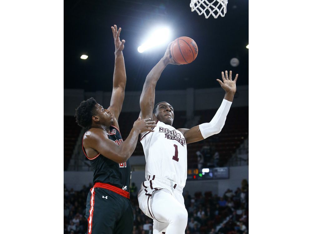 Mississippi State forward Reggie Perry (1) goes up for a shot as Austin  Peay guard Terry Taylor (21) tries to defend during the first half of an  NCAA college basketball game, Friday, Nov. 9, 2018, in Starkville, Miss.  (AP Photo/Butch Dill Stock Photo 