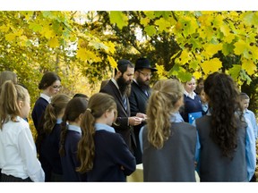 Rabbi Yehuda Teichtal, center right, and Rabbi David Gewirtz, center left, pray during an event to commemorate the victims of the Nov. 9, 1938 terror against the Jews in Germany at the Jewish Traditional School in Berlin, Wednesday, Nov. 7, 2018. On the event the school also remember to the victims of the anti-Semitic attack at the Tree of Life Synagogue in Pittsburgh, United States, on Saturday, Oct. 27, 2018.