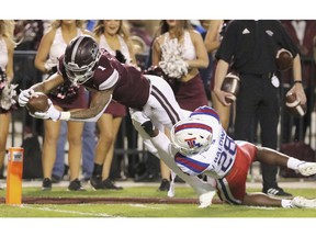 Mississippi State wide receiver Stephen Guidry (1) dives into the end zone for a touchdown as Louisiana Tech safety Jordan Baldwin (28) tries to stop him during the first half of an NCAA college football game on Saturday, Nov. 3, 2018, in Starkville, Miss.