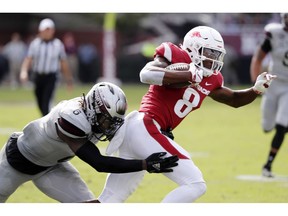 Arkansas wide receiver Michael Woods (8) tries to escape a tackle by Mississippi State linebacker Willie Gay Jr. (6) during the first half of an NCAA college football game in Starkville, Miss., Saturday, Nov. 17, 2018.