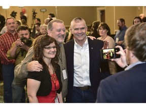Cindy Cronce, left, and Curt Edlin, center, of Helena, pose for a picture with Senate candidate Matt Rosendale after he greeted the room to say it would be a long night Tuesday, Nov. 6, 2018, in the Delta Hotel in Helena, Mont. Rosendale is challenging Sen. Jon Tester, D-Mont.