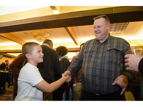 Montana Senator Jon Tester shakes hands with Jack Pinski Tuesday, Nov. 6, 2018, at his election party in Great Falls, Mont.