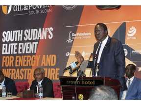 In this photo taken Tuesday, Nov. 20, 2018, South Sudan's Minister of Petroleum Ezekiel Lol Gatkuoth welcomes potential investors during the second Africa Oil and Power conference in the capital Juba, South Sudan. South Sudan is making its first big foreign investment pitch since declaring an end to its civil war, but the oil-rich nation seems to face hesitation from some companies that want to make sure the fragile new peace deal holds.