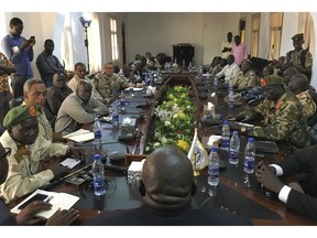 In this photo taken Thursday, Nov. 22, 2018, a South Sudan armed opposition commander Ashab Khamis, far-left, and a government army Gen. Keer Kiir Keer, far-right, attend high level talks where both sides exchanged accusations of violating the peace agreement, in Wau, South Sudan. The Associated Press witnessed the first meeting between the Wau region leaders of South Sudan's army and armed opposition since a groundbreaking peace deal, and the country's peace rests on whether the opposing sides can put a vicious past behind.