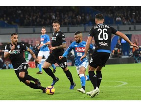 Napoli's forward Lorenzo Insigne, second from right, scores his side's first goal during the Italian Serie A soccer match between Napoli and Empoli at the San Paolo stadium in Naples, Italy, Friday, Nov. 2,  2018.