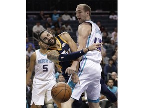 Utah Jazz's Ricky Rubio, left, loses the ball as Charlotte Hornets' Cody Zeller, right, defends during the first half of an NBA basketball game in Charlotte, N.C., Friday, Nov. 30, 2018.