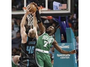 Boston Celtics' Jaylen Brown (7) blocks a shot by Charlotte Hornets' Cody Zeller (40) during the first half of an NBA basketball game in Charlotte, N.C., Monday, Nov. 19, 2018.