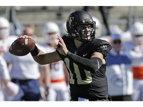 Wake Forest's Sam Hartman (10) looks to pass against Syracuse in the first half of an NCAA college football game in Charlotte, N.C., Saturday, Nov. 3, 2018.