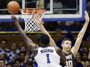 Duke's Zion Williamson (1) drives to the basket as Army's Ben Kinker (30) defends during the first half of an NCAA college basketball game in Durham, N.C., Sunday, Nov. 11, 2018.
