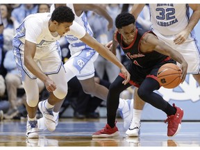 North Carolina guard Cameron Johnson, left, and St. Francis guard Ramiir Dixon-Conover (1) reach for the ballduring the first half of an NCAA college basketball game in Chapel Hill, N.C., Monday, Nov. 19, 2018.