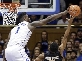 Duke's Zion Williamson,left, blocks a shot by Army's Josh Caldwell, right, during the second half of an NCAA college basketball game in Durham, N.C., Sunday, Nov. 11, 2018. Duke won 94-72.