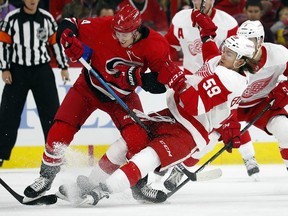 Carolina Hurricanes' Haydn Fleury (4) collides with Detroit Red Wings' Tyler Bertuzzi (59) during the first period of an NHL hockey game Saturday, Nov. 10, 2018, in Raleigh, N.C.