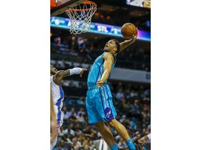 Charlotte Hornets forward Miles Bridges, right, dunks as Oklahoma City Thunder guard Dennis Schroeder, of Germany, defends during the first half of an NBA basketball game in Charlotte, N.C., Thursday, Nov. 1, 2018.