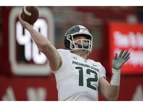 Michigan State quarterback Rocky Lombardi (12) warms up before an NCAA college football game against Nebraska in Lincoln, Neb., Saturday, Nov. 17, 2018.