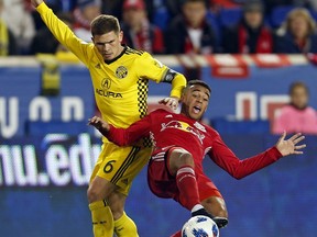 New York Red Bulls midfielder Tyler Adams (4) battles for the ball with Columbus Crew midfielder Will Trapp (6) during the first half of a soccer game, Sunday, Nov. 11, 2018 in Harrison, N.J.