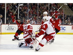 New Jersey Devils center Blake Coleman (20) celebrates scoring a goal past Detroit Red Wings goaltender Jonathan Bernier (45) with Devils center Travis Zajac (19) during the second period of an NHL hockey game Saturday, Nov. 17, 2018, in Newark, N.J.