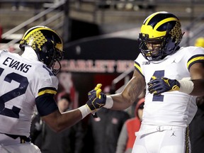 Michigan wide receiver Nico Collins, right, celebrates his touchdown catch with running back Chris Evans during the second half of an NCAA college football game against Rutgers, Saturday, Nov. 10, 2018, in Piscataway, N.J.