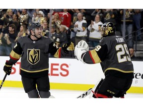 Vegas Golden Knights goalie Marc-Andre Fleury (29) congratulates defenseman Brad Hunt (77) after he scored against the Carolina Hurricanes during the first period of an NHL hockey game Saturday, Nov. 3, 2018, in Las Vegas.